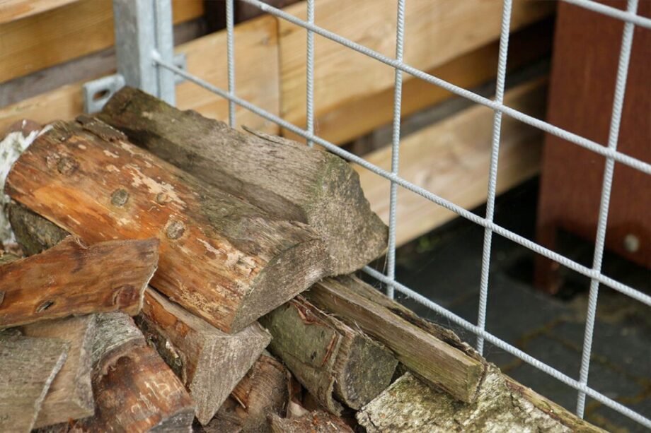 Detail van een stalen frame met netjes gestapeld brandhout